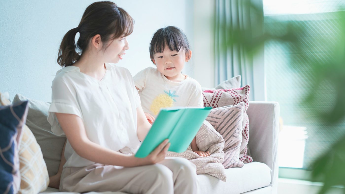 child reading with parent
