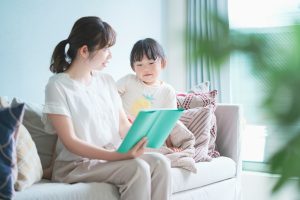 child reading with parent