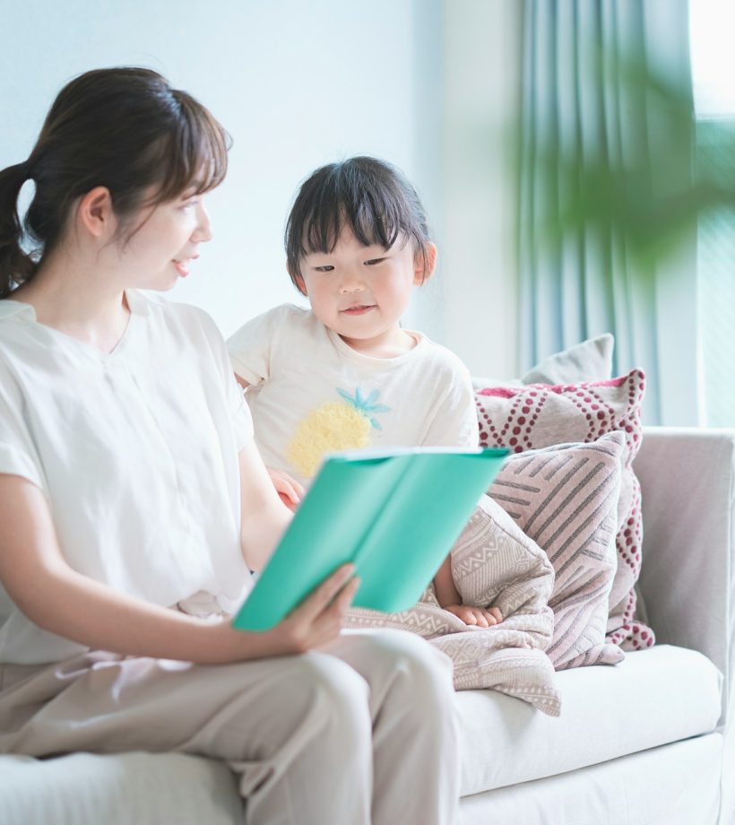 child reading with parent