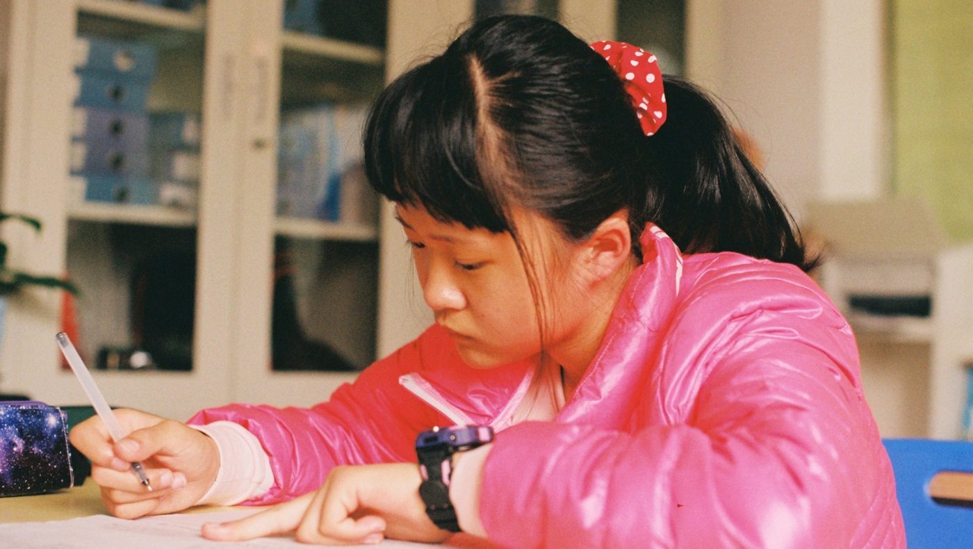 child writing a paper